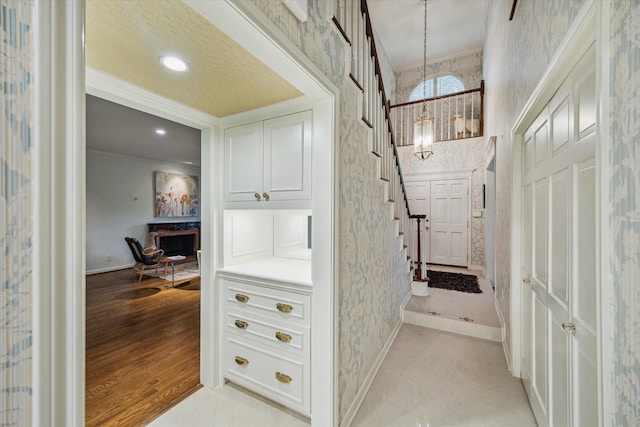 2628 Glen Haven Blvd, Houston, TX 77025 - bathroom with wallpapered walls, a chandelier, ornamental molding, wood finished floors, and recessed lighting