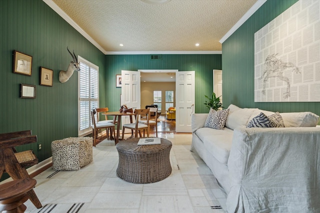 2628 Glen Haven Blvd, Houston, TX 77025 - living room featuring ornamental molding, healthy amount of natural light, and a textured ceiling