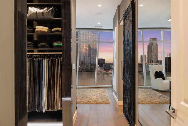 4521 San Felipe St Unit 1201, Houston, TX 77027 - spacious closet with wood finished floors and a barn door