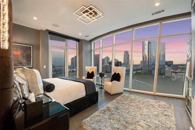4521 San Felipe St Unit 1201, Houston, TX 77027 - bedroom with access to exterior, a view of skyline, wood finished floors, expansive windows, and recessed lighting