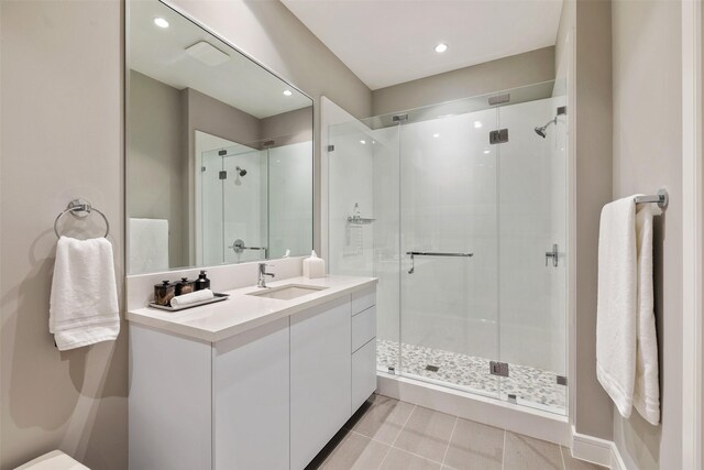 4521 San Felipe St Unit 1201, Houston, TX 77027 - full bathroom featuring vanity, a shower stall, tile patterned floors, and recessed lighting