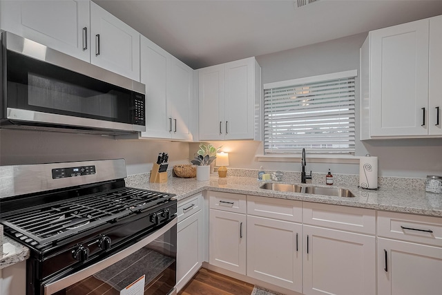 2218 Silverbonnet St, Houston, TX 77055 - kitchen featuring stainless steel appliances, white cabinetry, and light stone counters