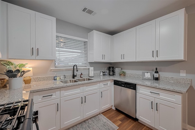 2218 Silverbonnet St, Houston, TX 77055 - kitchen featuring dishwasher, white cabinetry, dark wood-style flooring, light stone countertops, and gas range oven