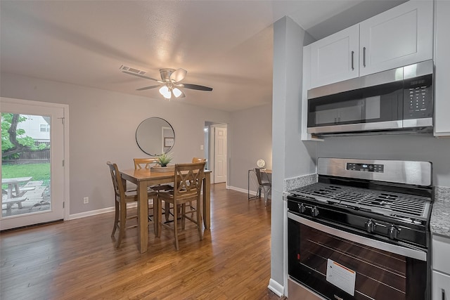 2218 Silverbonnet St, Houston, TX 77055 - kitchen with appliances with stainless steel finishes, wood finished floors, white cabinetry, and ceiling fan