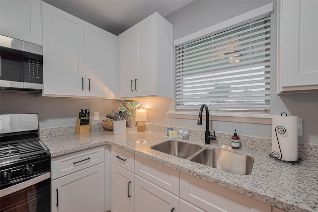 2218 Silverbonnet St, Houston, TX 77055 - kitchen with stainless steel appliances, white cabinets, and light stone countertops