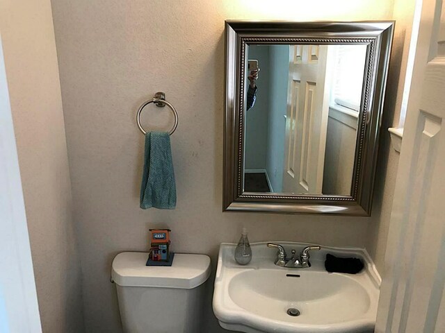 5734 Arthington St, Houston, TX 77053 - half bathroom with a sink and toilet
