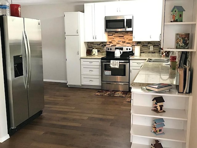 5734 Arthington St, Houston, TX 77053 - kitchen with appliances with stainless steel finishes, open shelves, dark wood finished floors, light countertops, and a sink