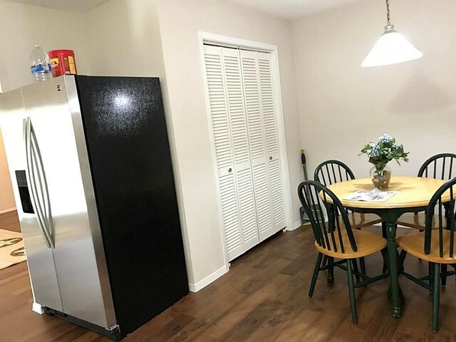 5734 Arthington St, Houston, TX 77053 - dining space featuring dark wood-style floors and baseboards