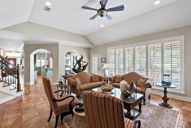 926 Grand Oaks Cir, College Station, TX 77840 - living room featuring arched walkways, ceiling fan, baseboards, vaulted ceiling, and stairway