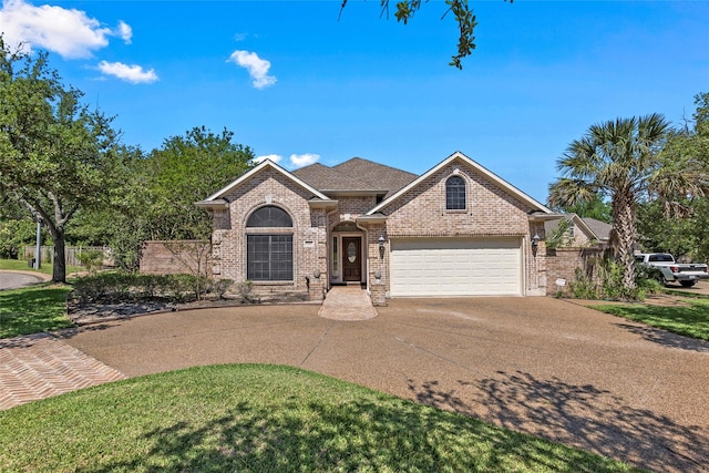 926 Grand Oaks Cir, College Station, TX 77840 - view of front of home featuring brick siding, concrete driveway, a garage, and roof with shingles