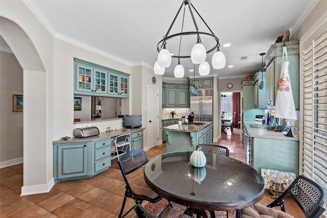 926 Grand Oaks Cir, College Station, TX 77840 - tiled dining space with ornamental molding, arched walkways, baseboards, and recessed lighting