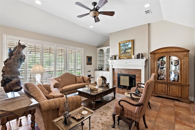 926 Grand Oaks Cir, College Station, TX 77840 - living area featuring lofted ceiling, a ceiling fan, a tiled fireplace, recessed lighting, and built in features