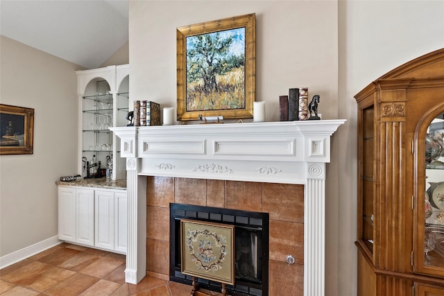 926 Grand Oaks Cir, College Station, TX 77840 - living area with a tile fireplace, lofted ceiling, and baseboards