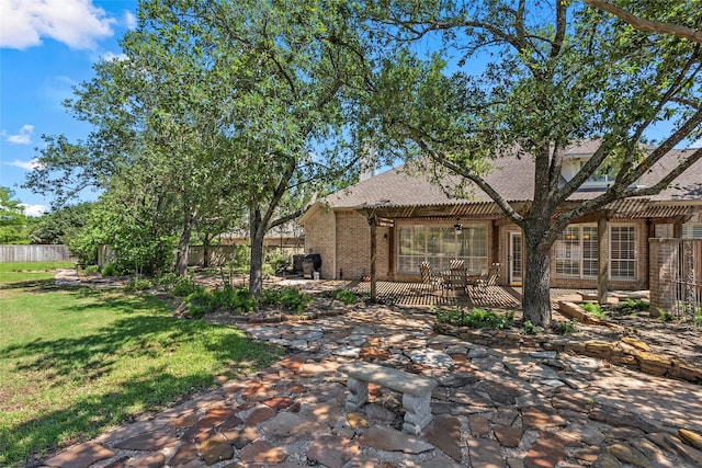 926 Grand Oaks Cir, College Station, TX 77840 - back of house with ceiling fan, a patio, brick siding, and a pergola