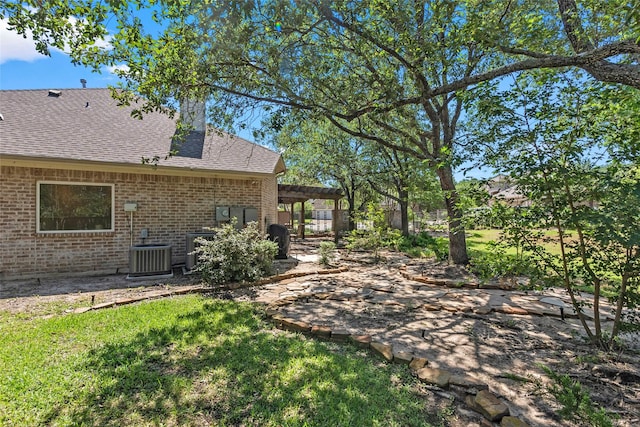 926 Grand Oaks Cir, College Station, TX 77840 - view of yard featuring a patio area and central AC