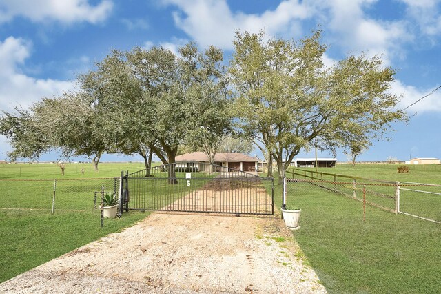 6720 Kacal Rd, Beasley, TX 77417 - view of front of property with a gate, a view of rural / pastoral area, and dirt driveway