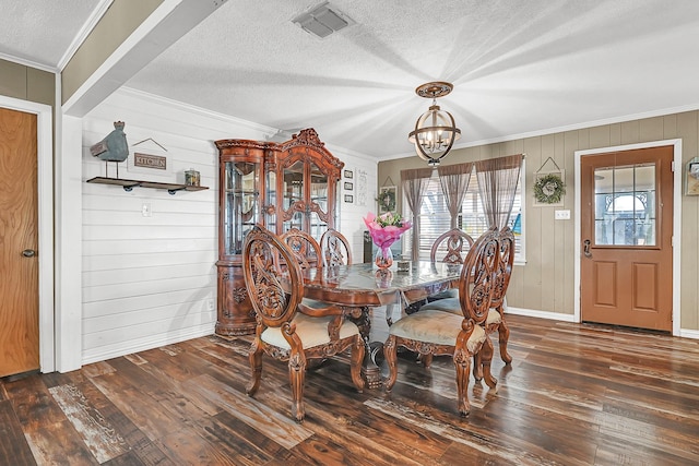 6720 Kacal Rd, Beasley, TX 77417 - dining space with wood-type flooring, a chandelier, crown molding, baseboards, and a textured ceiling