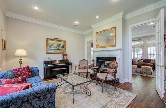 4516 Palmetto St, Bellaire, TX 77401 - living room featuring wood finished floors, ornamental molding, a glass covered fireplace, recessed lighting, and baseboards