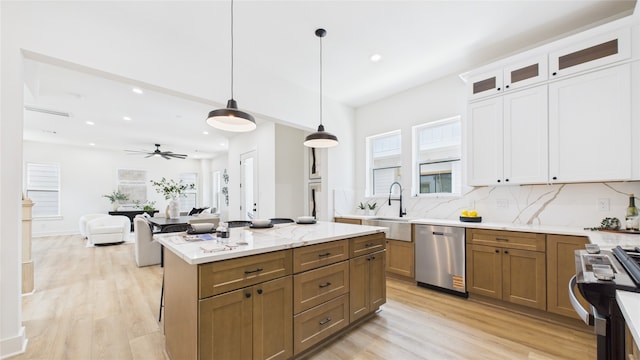 1637 Beall St, Houston, TX 77008 - kitchen featuring stainless steel appliances, recessed lighting, light wood-style floors, tasteful backsplash, and white cabinetry