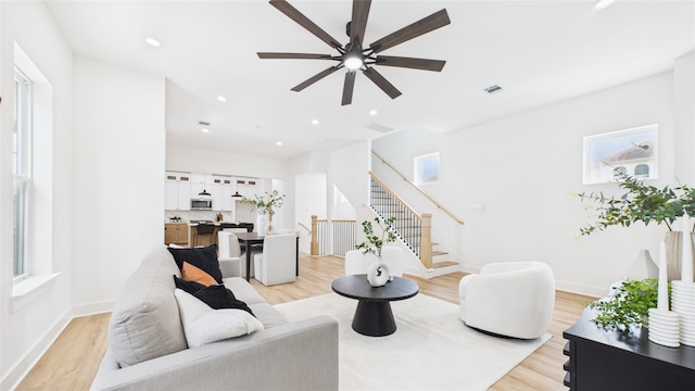 1637 Beall St, Houston, TX 77008 - living room featuring stairway, ceiling fan, light wood-style floors, and recessed lighting
