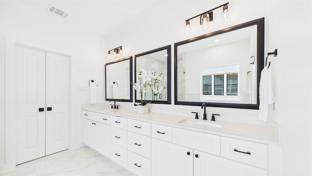 1637 Beall St, Houston, TX 77008 - bathroom featuring double vanity, marble finish flooring, and a shower with shower door