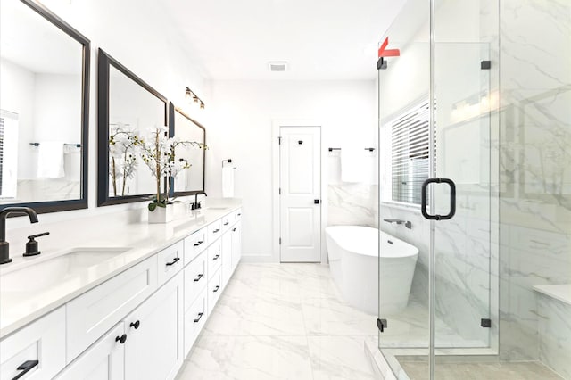 1637 Beall St, Houston, TX 77008 - bathroom featuring marble finish floors, a freestanding bath, double vanity, and a marble finish shower
