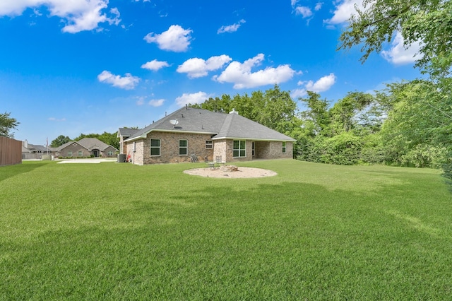281 Berkley Dr, Montgomery, TX 77356 - back of property with a lawn, brick siding, and a chimney