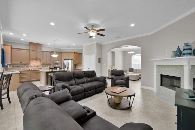 281 Berkley Dr, Montgomery, TX 77356 - living area featuring arched walkways, ceiling fan, recessed lighting, light tile patterned floors, and ornamental molding