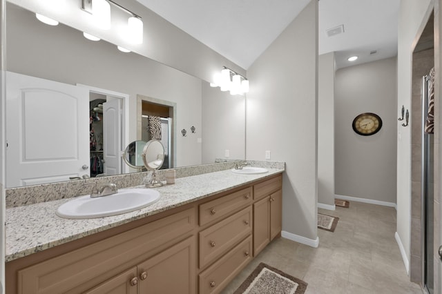 281 Berkley Dr, Montgomery, TX 77356 - full bathroom with double vanity, a stall shower, a spacious closet, lofted ceiling, and tile patterned floors