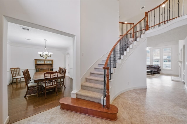 3602 Lindhaven Dr, Pearland, TX 77584 - stairs featuring a chandelier, a towering ceiling, crown molding, baseboards, and tile patterned flooring