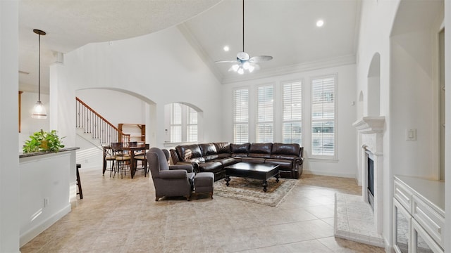 3602 Lindhaven Dr, Pearland, TX 77584 - living room featuring ceiling fan, light tile patterned flooring, high vaulted ceiling, baseboards, and crown molding