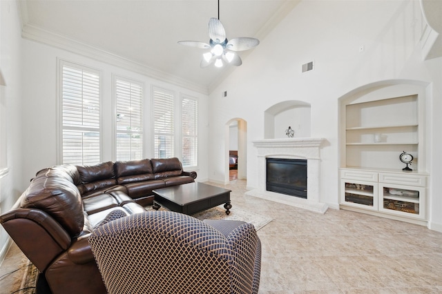 3602 Lindhaven Dr, Pearland, TX 77584 - living area featuring built in features, ceiling fan, ornamental molding, a glass covered fireplace, and baseboards