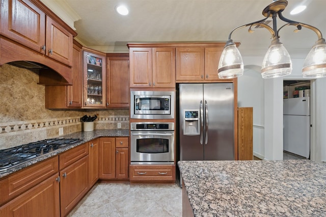 3602 Lindhaven Dr, Pearland, TX 77584 - kitchen featuring stainless steel appliances, dark stone counters, brown cabinets, decorative backsplash, and glass insert cabinets