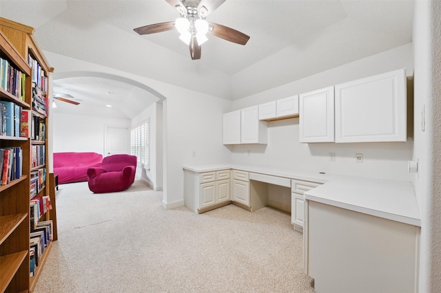 3602 Lindhaven Dr, Pearland, TX 77584 - home office featuring ceiling fan, built in desk, light carpet, arched walkways, and lofted ceiling