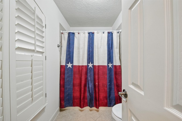 3602 Lindhaven Dr, Pearland, TX 77584 - full bathroom with toilet, tile patterned floors, a shower with shower curtain, and a textured ceiling