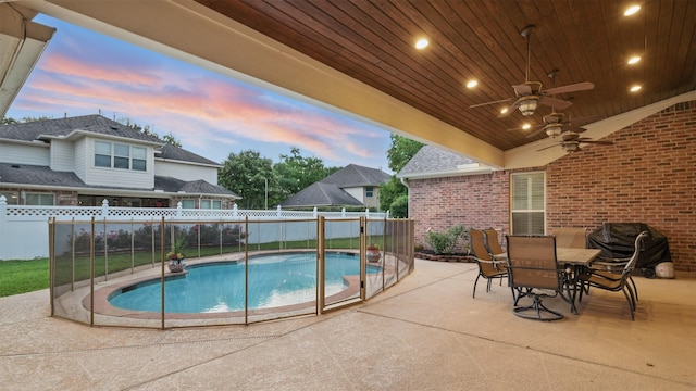 3602 Lindhaven Dr, Pearland, TX 77584 - pool at dusk with a patio, a ceiling fan, a grill, and outdoor dining space