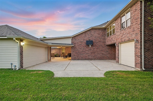 3602 Lindhaven Dr, Pearland, TX 77584 - garage at dusk featuring concrete driveway and a yard