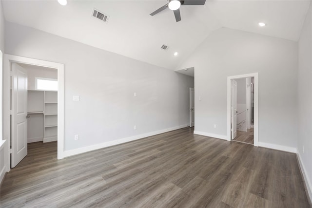 4923 Golden Forest Dr, Houston, TX 77091 - unfurnished bedroom with a walk in closet, a ceiling fan, high vaulted ceiling, wood finished floors, and baseboards