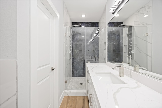 4923 Golden Forest Dr, Houston, TX 77091 - full bathroom featuring vanity, a marble finish shower, and wood finished floors