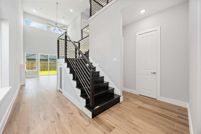 4923 Golden Forest Dr, Houston, TX 77091 - stairway featuring plenty of natural light, a ceiling fan, wood finished floors, recessed lighting, and a high ceiling