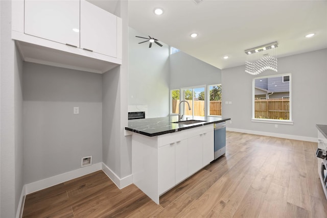 4923 Golden Forest Dr, Houston, TX 77091 - kitchen featuring dishwasher, a sink, white cabinets, dark countertops, and recessed lighting