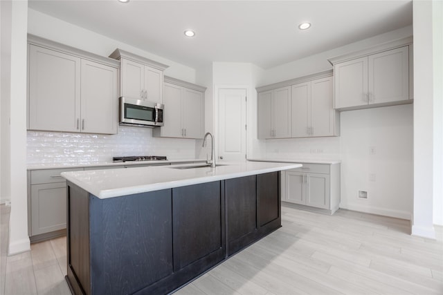 833 Laguna Green Ln, Katy, TX 77493 - kitchen featuring stainless steel appliances, a sink, gray cabinetry, tasteful backsplash, and recessed lighting