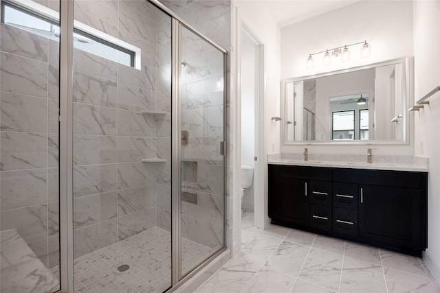 833 Laguna Green Ln, Katy, TX 77493 - bathroom featuring double vanity, toilet, marble finish flooring, and a shower stall