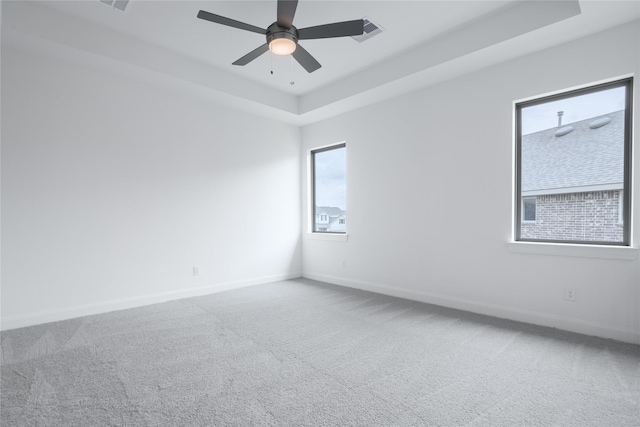 833 Laguna Green Ln, Katy, TX 77493 - empty room with carpet flooring, baseboards, a tray ceiling, and a ceiling fan