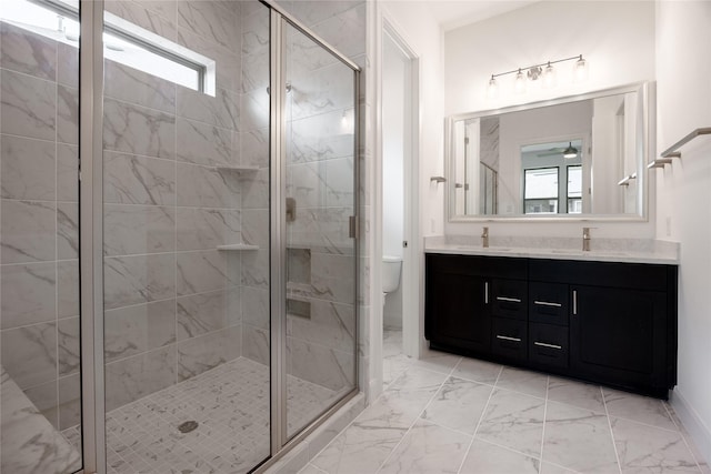 833 Laguna Green Ln, Katy, TX 77493 - bathroom with double vanity, marble look tile flooring, toilet, a stall shower, and ceiling fan