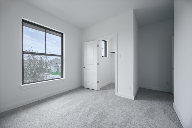 833 Laguna Green Ln, Katy, TX 77493 - unfurnished bedroom featuring multiple windows, carpet flooring, baseboards, and a spacious closet