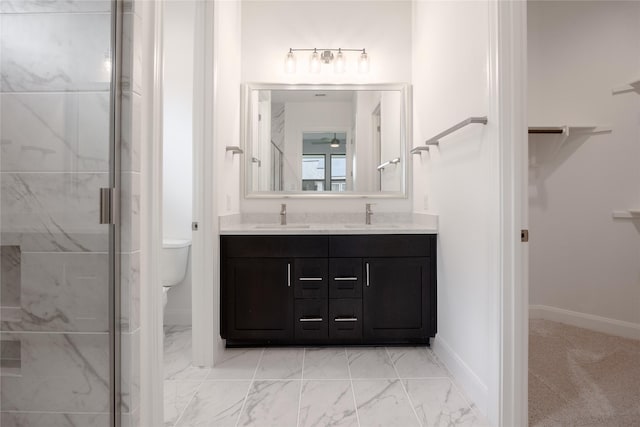 833 Laguna Green Ln, Katy, TX 77493 - full bath with double vanity, a marble finish shower, marble look tiles, toilet, and a spacious closet
