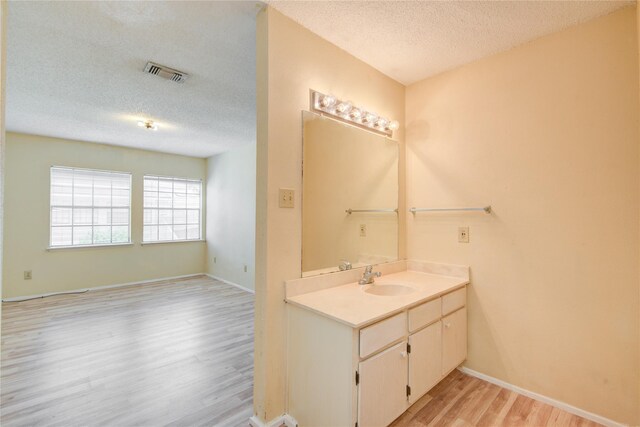 6103 Ludington Dr Unit 4-941, Houston, TX 77035 - bathroom with a textured ceiling, wood finished floors, vanity, and baseboards