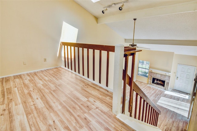 6103 Ludington Dr Unit 4-941, Houston, TX 77035 - hall featuring wood finished floors, a skylight, track lighting, and baseboards