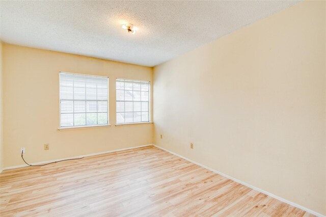6103 Ludington Dr Unit 4-941, Houston, TX 77035 - unfurnished room featuring wood finished floors, a textured ceiling, and baseboards